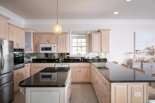 kitchen featuring ornamental molding, light brown cabinetry, a sink, dark countertops, and appliances with stainless steel finishes