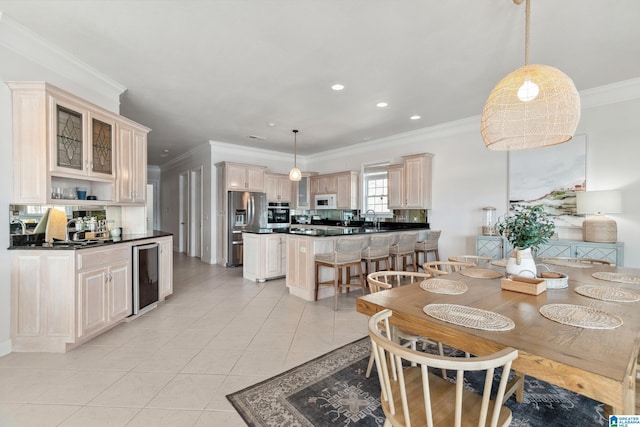 dining space with recessed lighting, beverage cooler, light tile patterned flooring, and ornamental molding