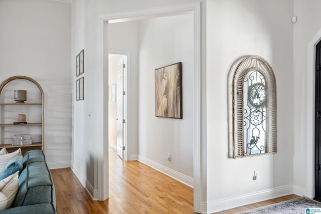 foyer featuring baseboards and light wood-type flooring