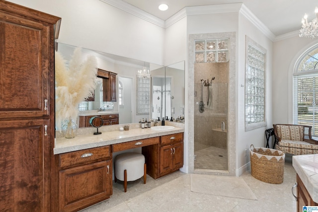 bathroom featuring vanity, a shower stall, crown molding, and a chandelier