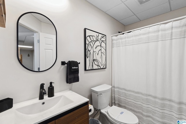 bathroom with visible vents, a drop ceiling, toilet, a shower with curtain, and vanity