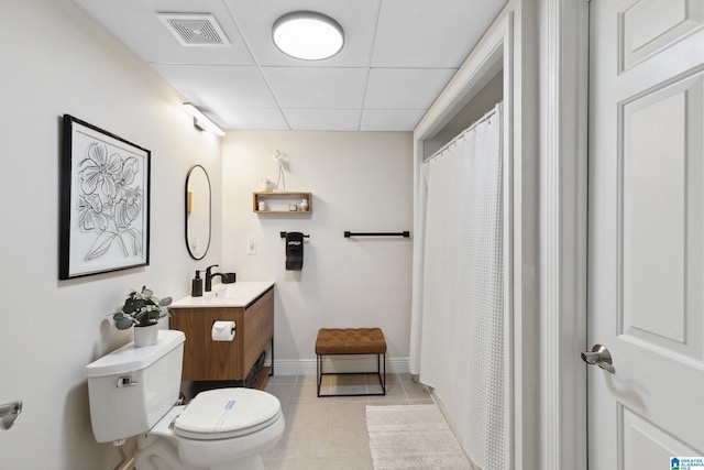 full bathroom featuring tile patterned floors, visible vents, toilet, a paneled ceiling, and vanity