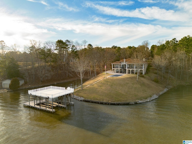 dock area featuring a yard, a water view, and boat lift