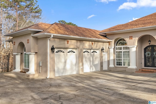 garage featuring concrete driveway