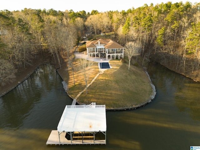 bird's eye view with a forest view and a water view