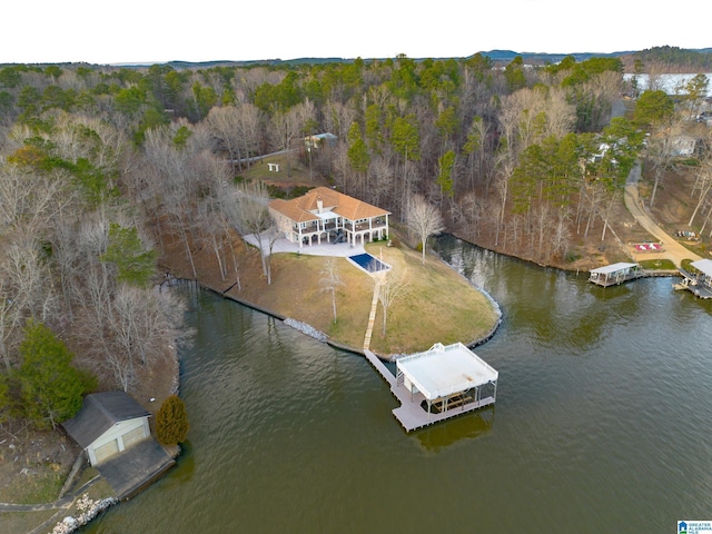 drone / aerial view featuring a view of trees and a water view