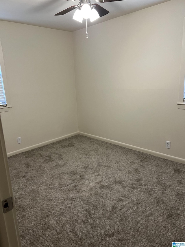 empty room featuring baseboards, a ceiling fan, and carpet