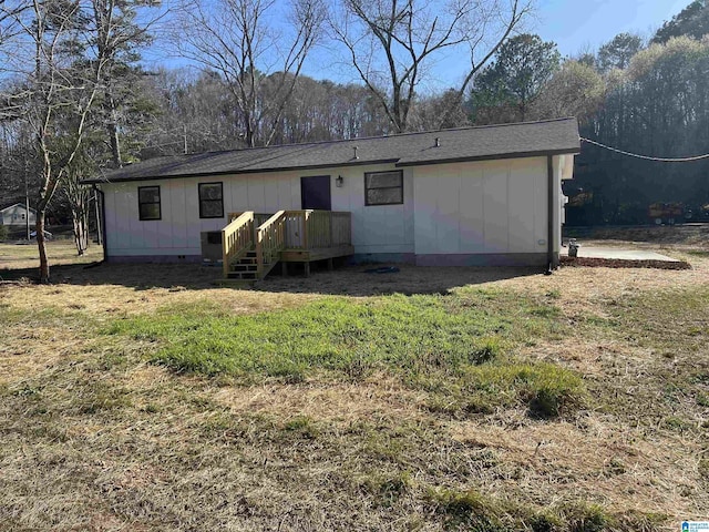 rear view of property with crawl space, a yard, and a wooden deck