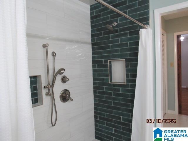 full bathroom with a tile shower