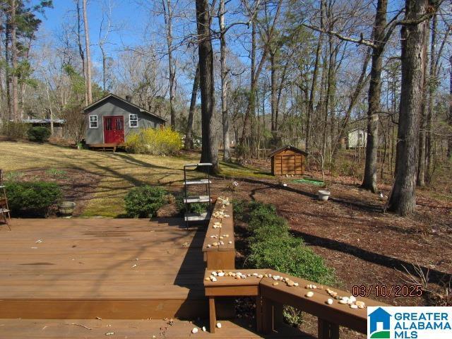 deck featuring a storage shed and an outbuilding