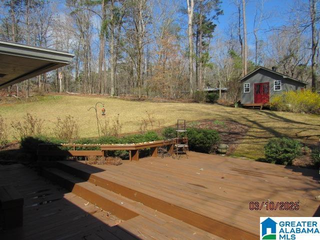 wooden deck with an outbuilding