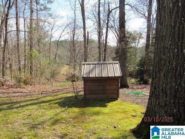 view of outdoor structure featuring a wooded view