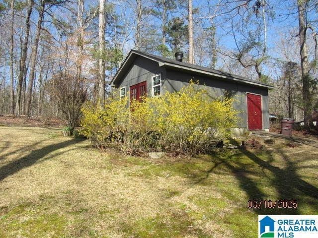 view of property exterior with a lawn