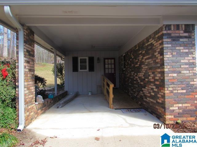 doorway to property with brick siding and board and batten siding