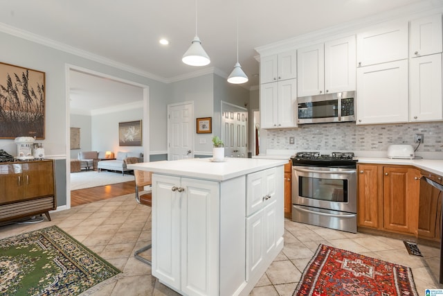 kitchen with backsplash, light countertops, ornamental molding, stainless steel appliances, and white cabinetry