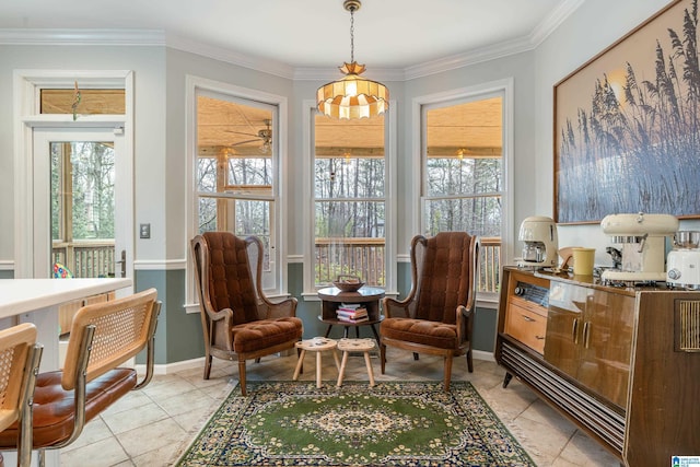 living area featuring baseboards and crown molding