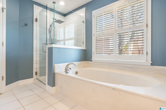 full bathroom with tile patterned flooring, a garden tub, baseboards, and a stall shower