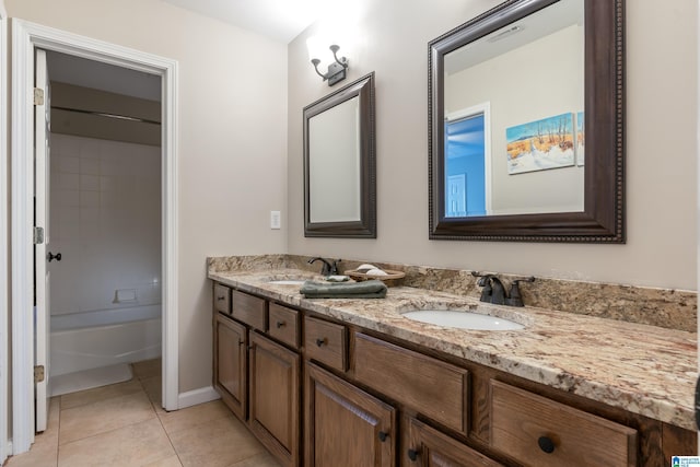 full bathroom featuring a sink, visible vents, double vanity, and tile patterned floors