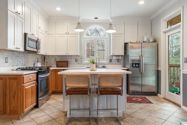 kitchen with a sink, tasteful backsplash, white cabinetry, appliances with stainless steel finishes, and light countertops