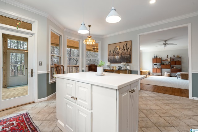 kitchen with light tile patterned floors and ornamental molding