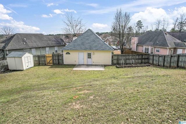 rear view of house with an outbuilding, a lawn, a patio, a fenced backyard, and a shed