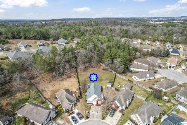 drone / aerial view with a residential view and a wooded view