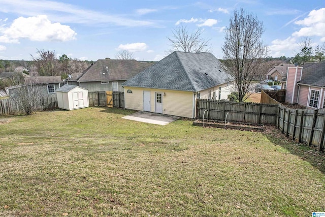 rear view of property with a patio, a fenced backyard, an outdoor structure, a storage unit, and a lawn