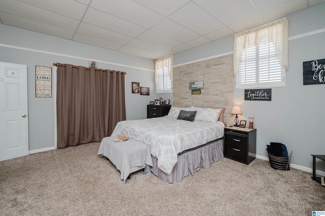 bedroom with carpet, baseboards, and a paneled ceiling