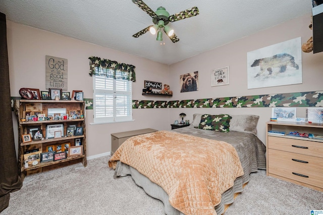 bedroom featuring a ceiling fan, baseboards, carpet floors, and a textured ceiling