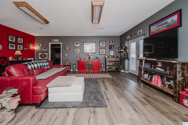 living area featuring a textured ceiling and wood finished floors