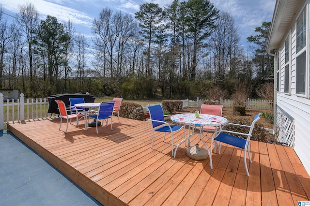 wooden deck featuring outdoor dining space and fence