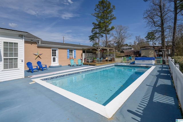 view of pool featuring a deck, a fenced in pool, a patio, and fence