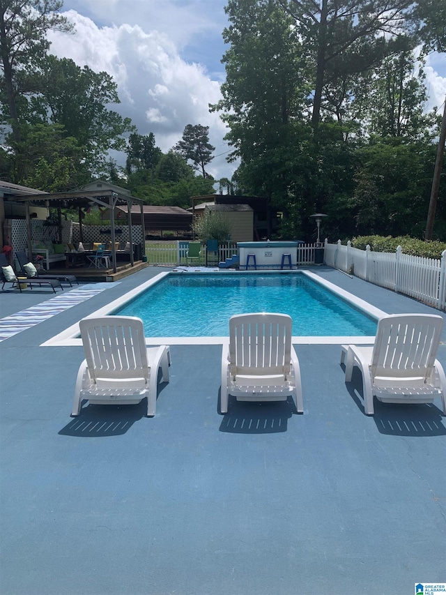 view of swimming pool with a gazebo, a patio area, a fenced in pool, and fence