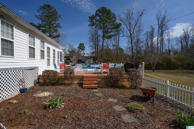 view of yard with a pool, a deck, and fence