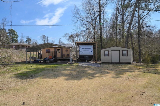 view of shed with a detached carport and driveway