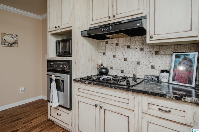 kitchen featuring under cabinet range hood, black gas cooktop, crown molding, stainless steel oven, and dark wood-style flooring