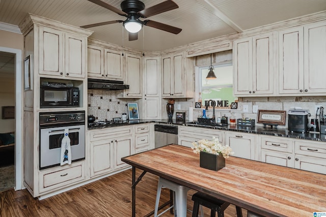 kitchen with oven, under cabinet range hood, backsplash, stainless steel dishwasher, and black microwave