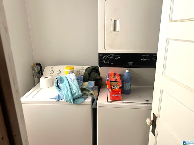 clothes washing area with laundry area and stacked washing maching and dryer