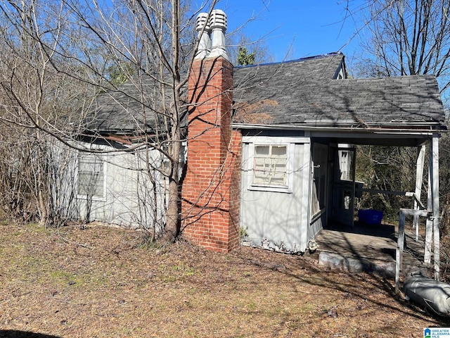 view of property exterior with roof with shingles