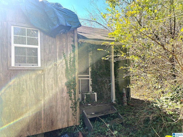 view of property exterior with roof with shingles