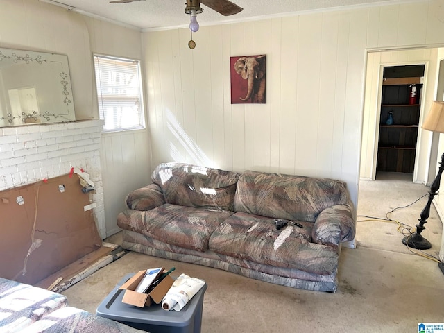 living room with a ceiling fan and crown molding