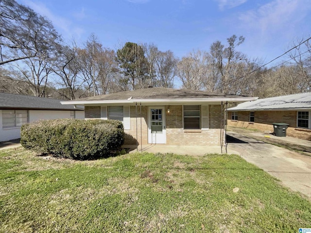 view of front of home with brick siding and a front yard