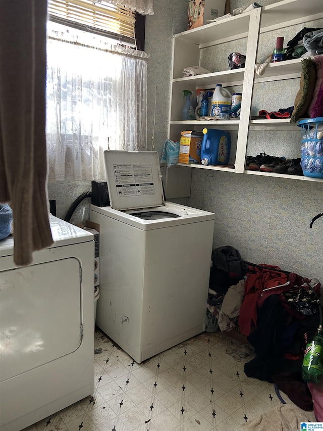 washroom with tile patterned floors, laundry area, and washing machine and clothes dryer