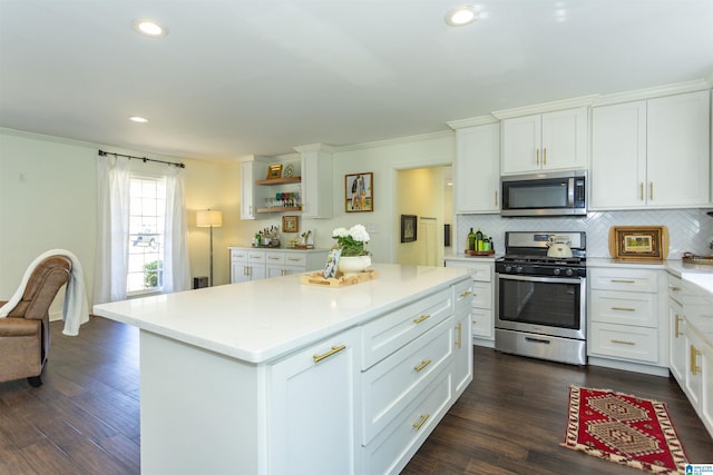 kitchen with tasteful backsplash, appliances with stainless steel finishes, and dark wood finished floors