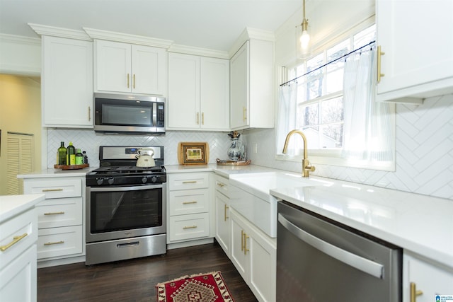 kitchen with light countertops, white cabinets, and appliances with stainless steel finishes