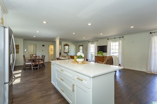 kitchen featuring ornate columns, open floor plan, dark wood-style flooring, and freestanding refrigerator