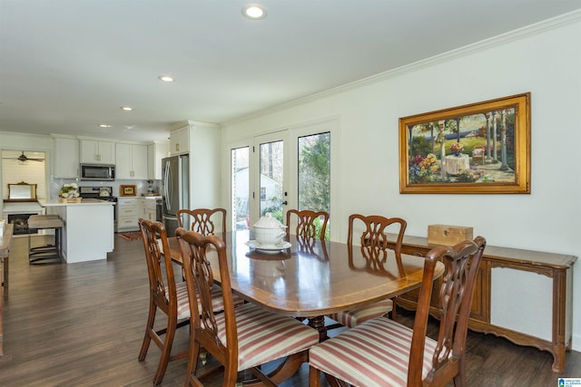 dining room with crown molding, recessed lighting, and dark wood-type flooring