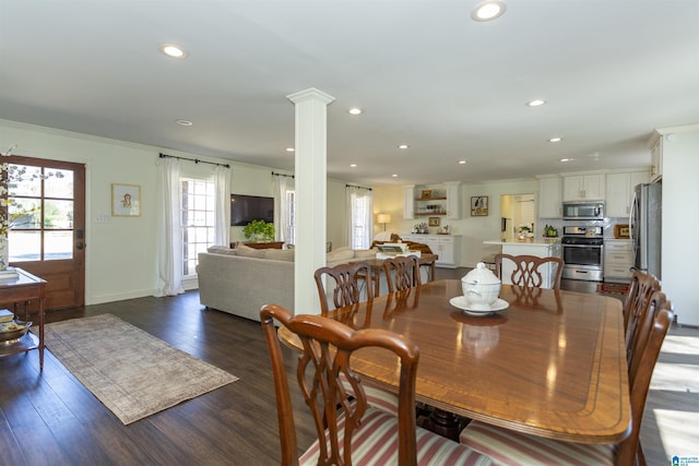 dining room featuring dark wood-style floors, recessed lighting, ornamental molding, and decorative columns