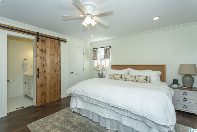 bedroom with connected bathroom, crown molding, a barn door, wood finished floors, and a ceiling fan