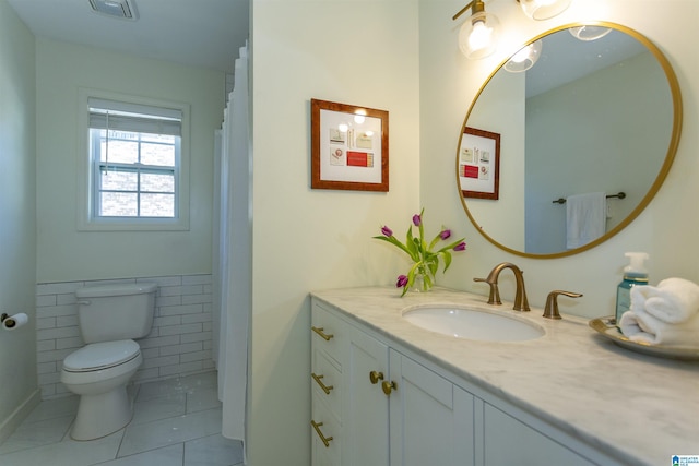 full bathroom with tile patterned flooring, visible vents, tile walls, toilet, and vanity